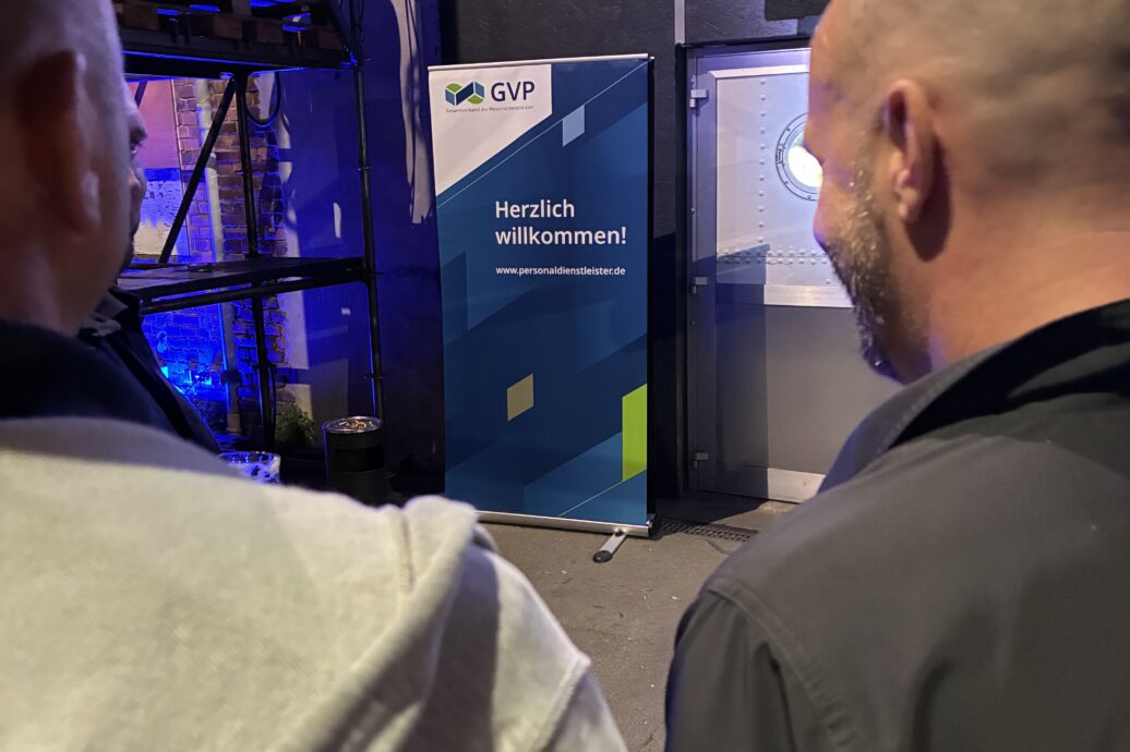 Blick auf Bühne über die Schultern zweier Besucher